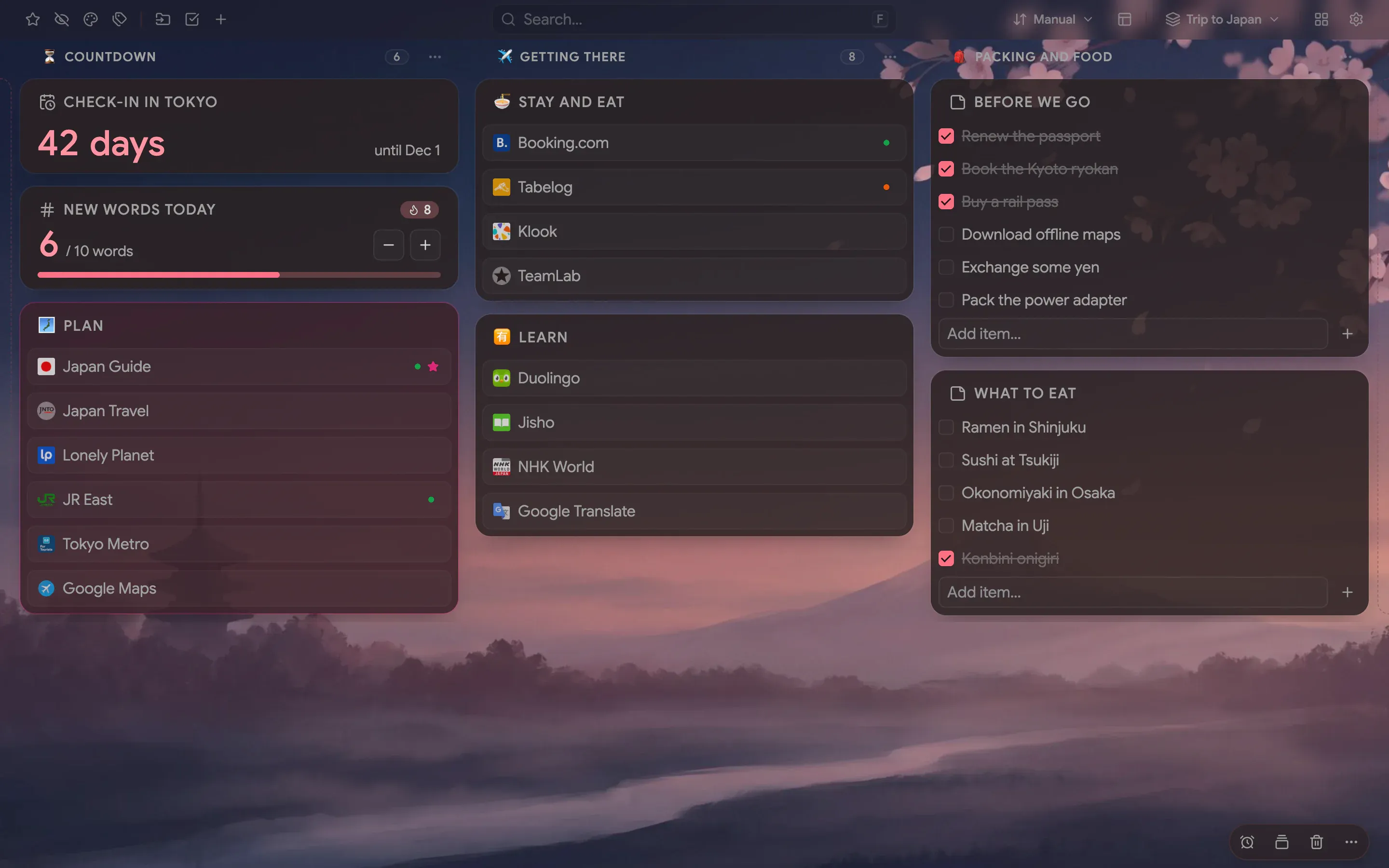 A Trip to Japan board over a dusk painting of Mount Fuji, with see-through folders in three named columns, a check-in countdown, a word counter and checklists